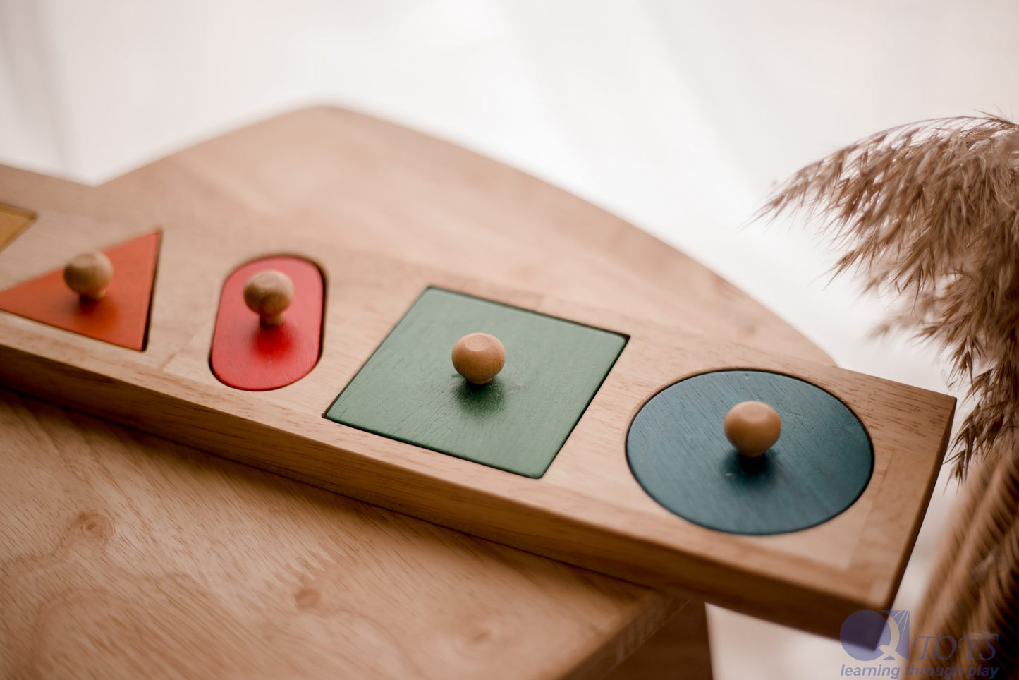 QToys Giant Shape Knobbed Puzzle - Wooden Montessori toy, on a table.