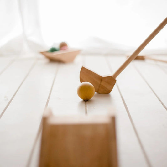 QToys Wooden toy golf set on a light wooden floor