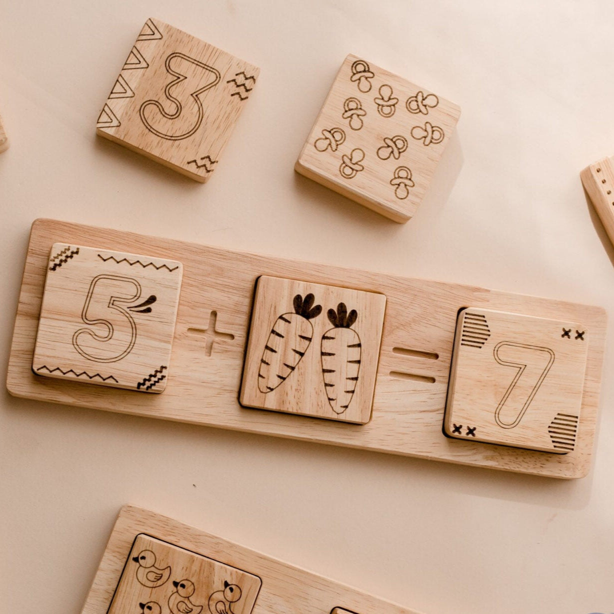 Wooden Two Piece Math Frame by QToys. educational blocks with numbers and arithmetic symbols on a light background